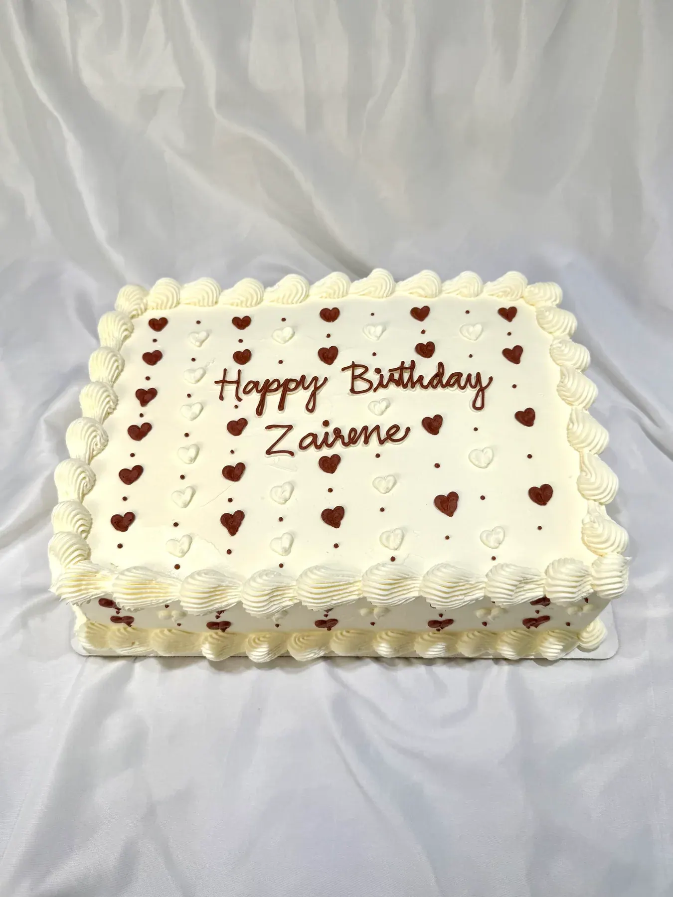 Happy birthday sheet cake piped with small red hearts