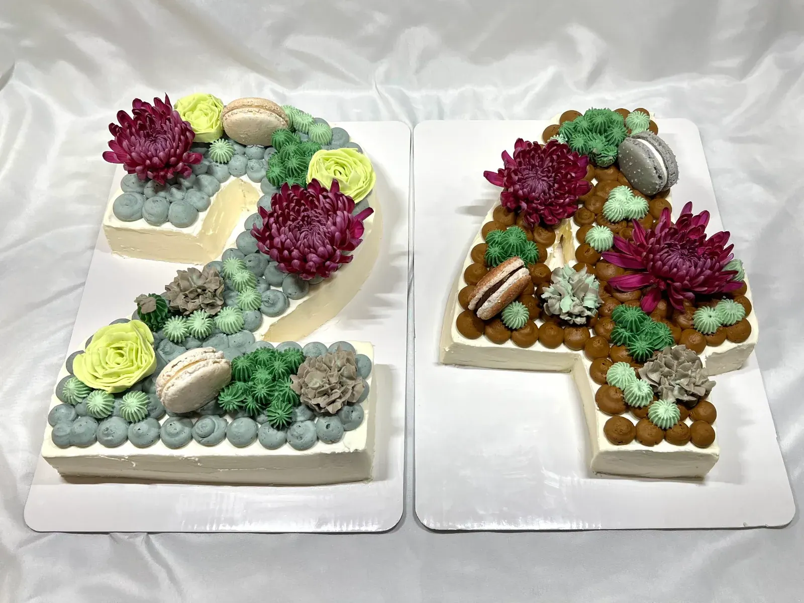 Number 2 and 4 cakes topped with piped succulents, flowers, macarons and chocolate pearls