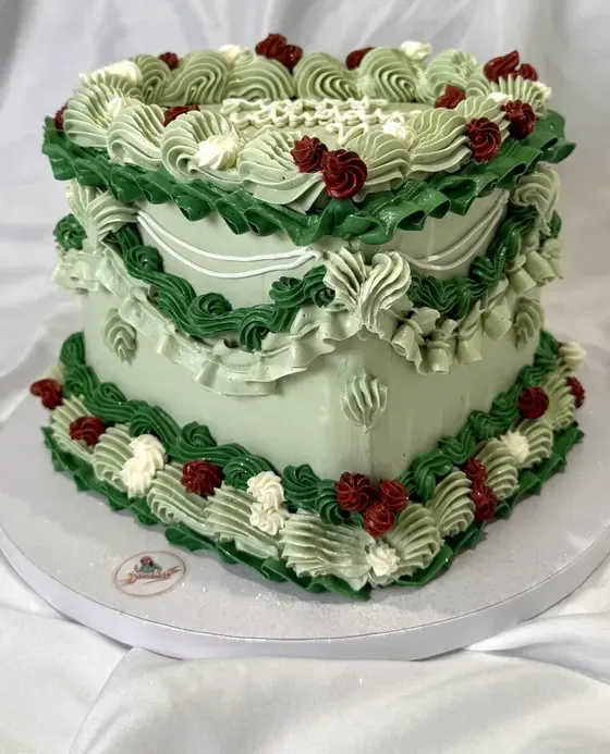 Vintage heart cake piped in sage and forest green with burgundy rosettes